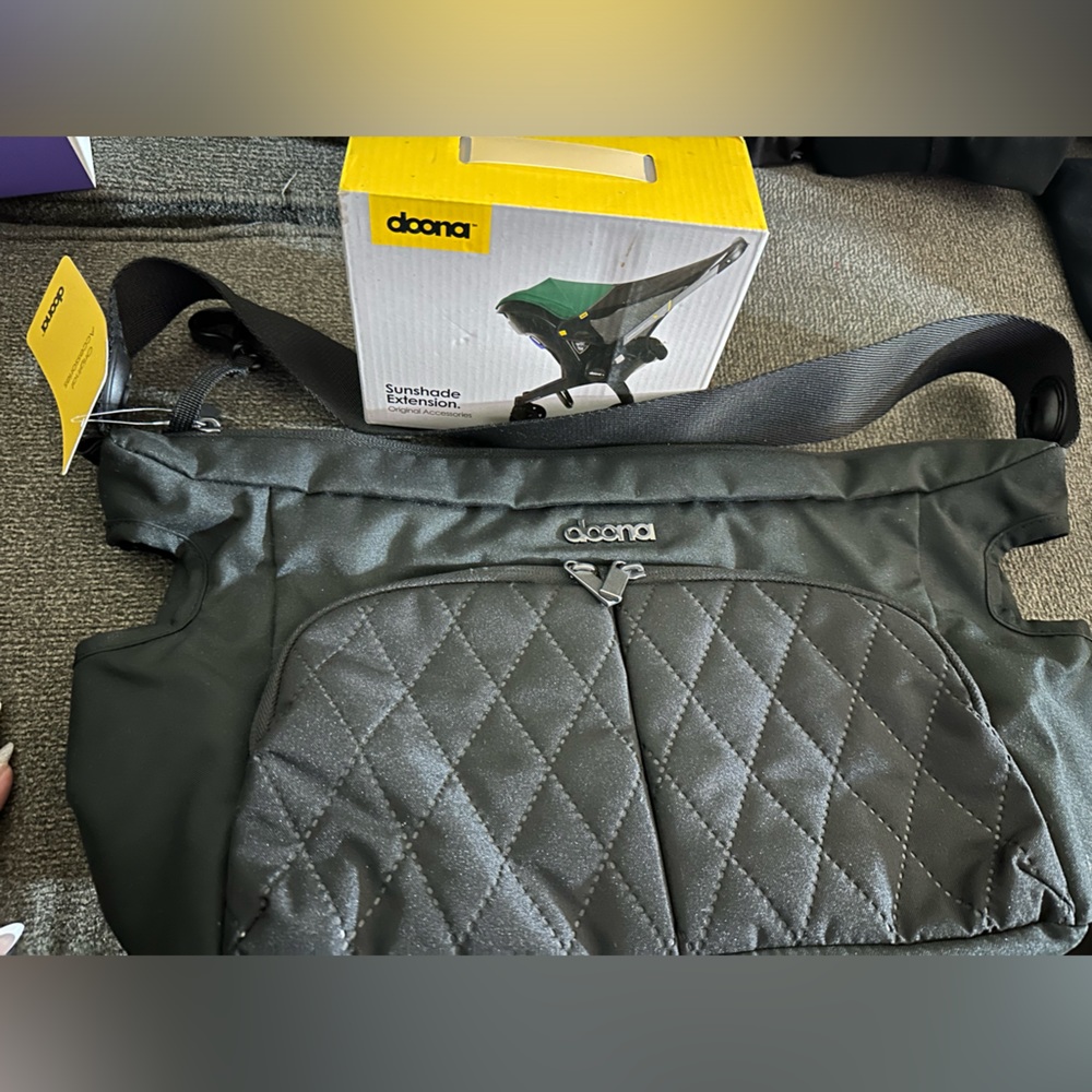 Brand new, Doona attachment, diaper bag, and Doona sunshade extension never used